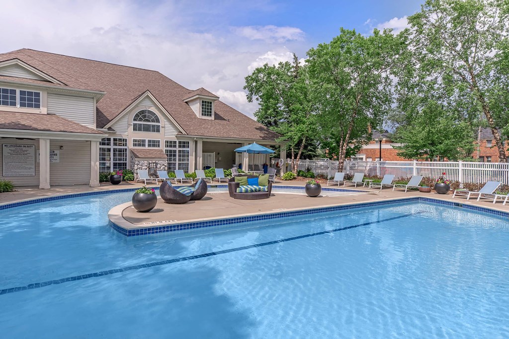 a swimming pool with a house in the background