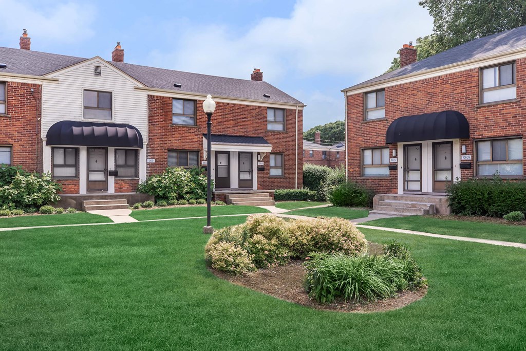 a group of houses with a yard and grass