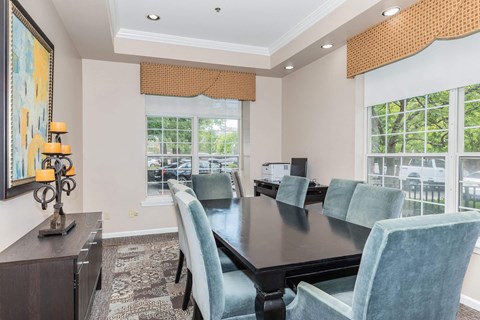A dining room with a dark table and blue chairs.