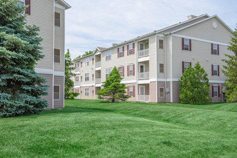 a large lawn in front of some apartments