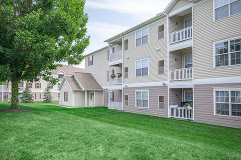 a row of houses with a lawn in front of them