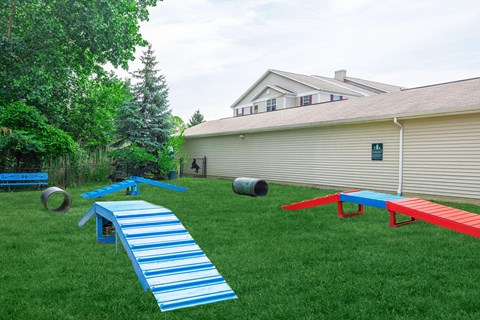 a backyard play area with a picnic table and benches