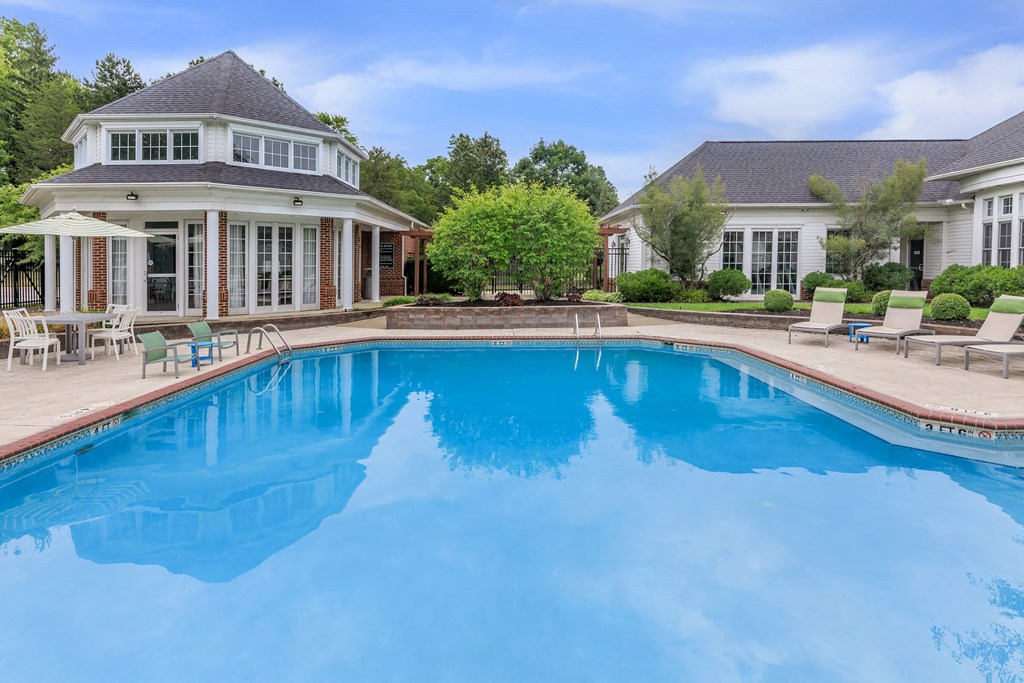 a swimming pool with a house in the background