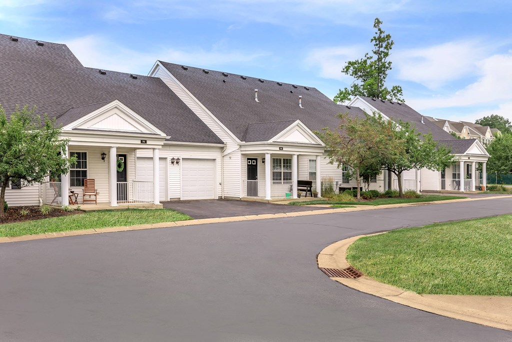 a large white house with a street in front of it