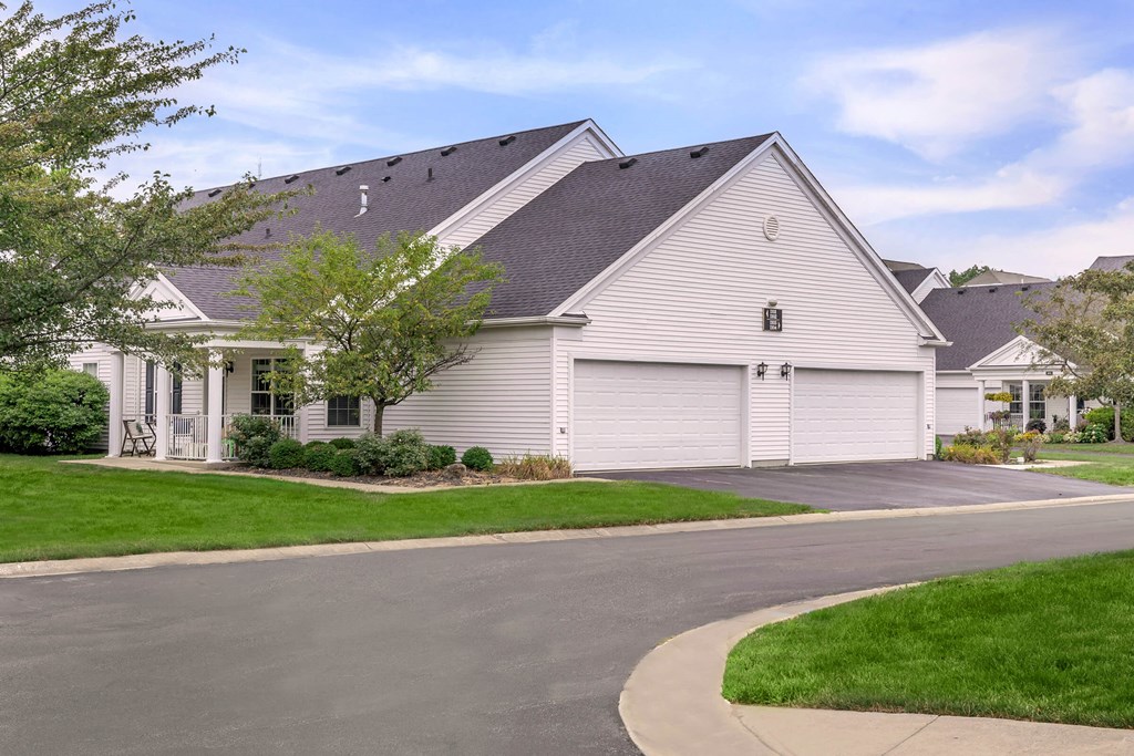 a white house with a street in front of it