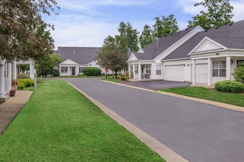 an empty street in front of a row of houses