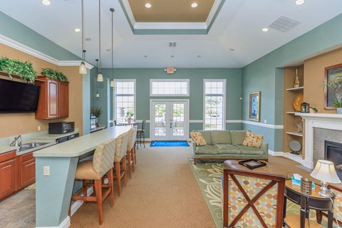 A kitchen with a dining table and chairs.