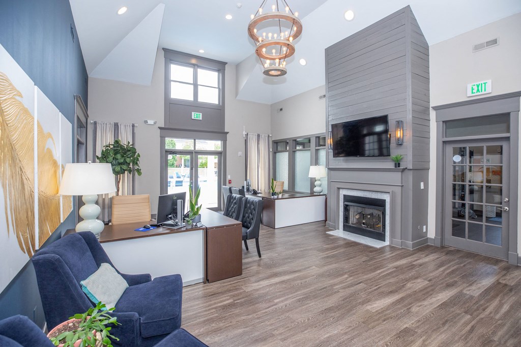 a living room with a fireplace and a desk