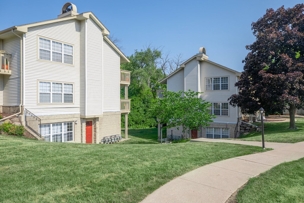 two houses on the side of a sidewalk