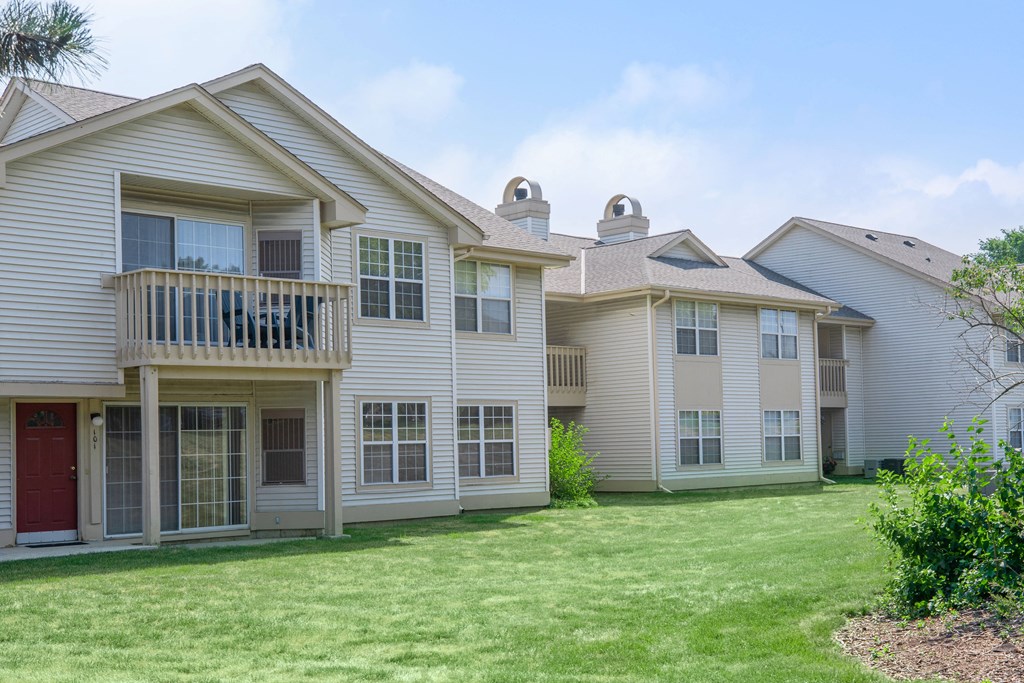 a group of houses on the side of a lawn