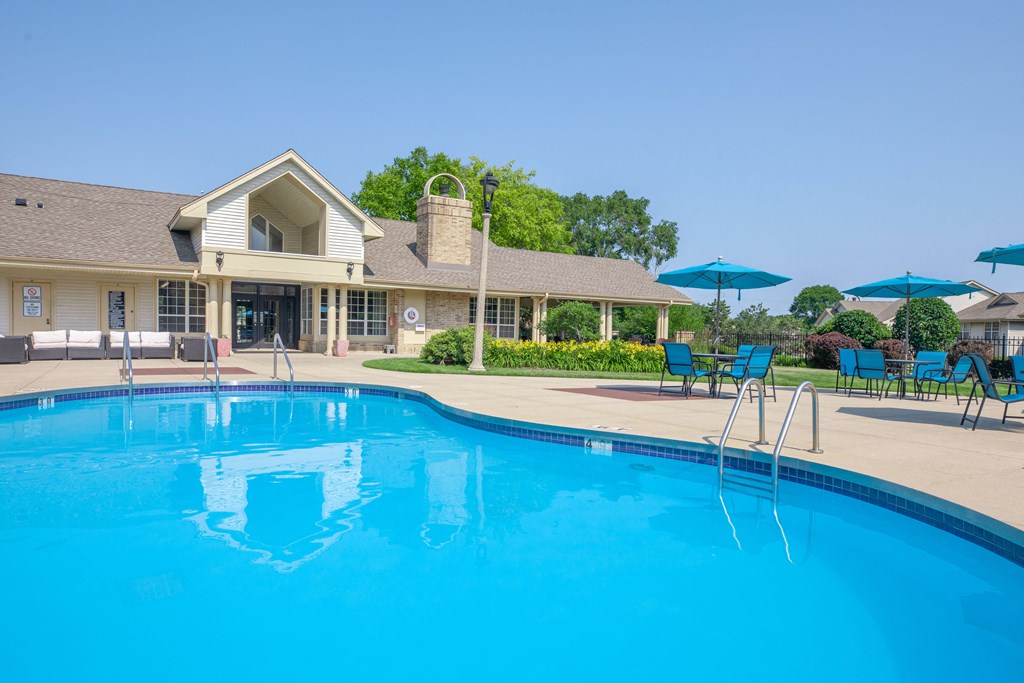 a swimming pool with a house in the background