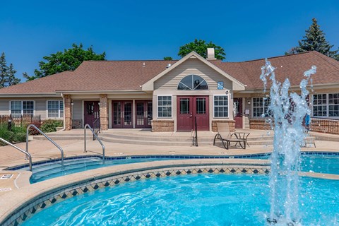 a swimming pool with a house in the background