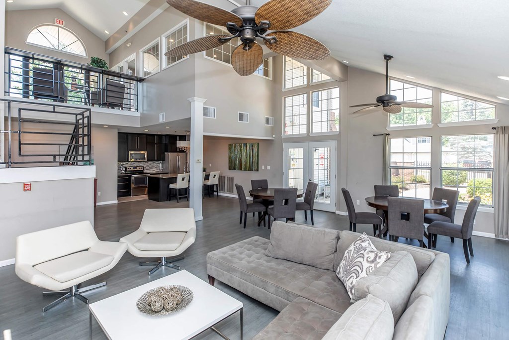 a living room with a couch and a ceiling fan