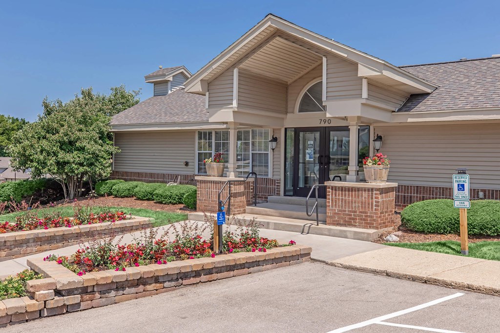 the front of a house with a driveway and landscaping