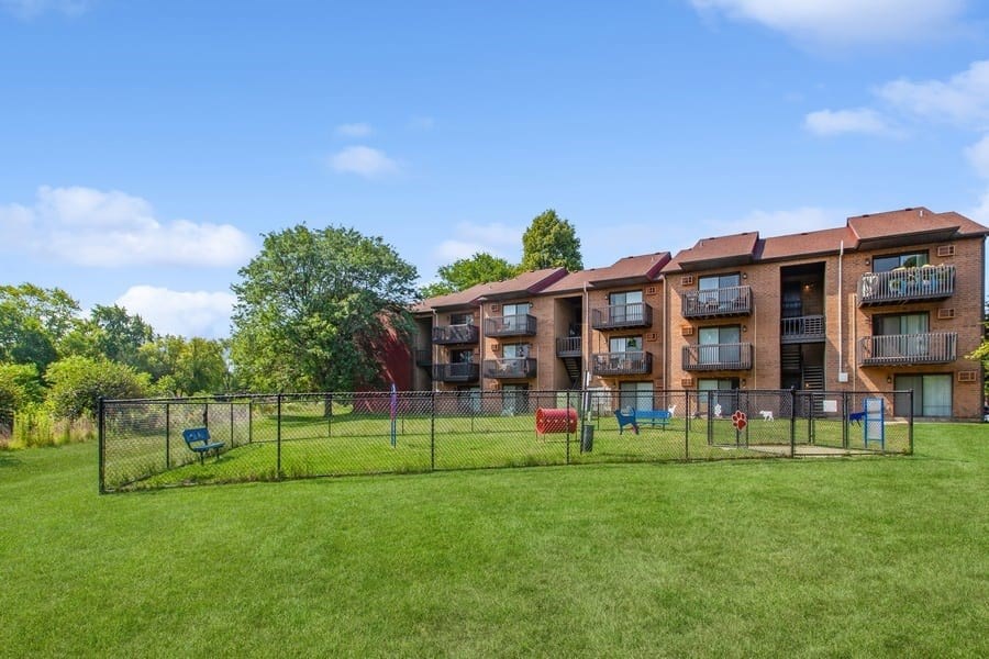 Apartment complex with a green lawn in front.