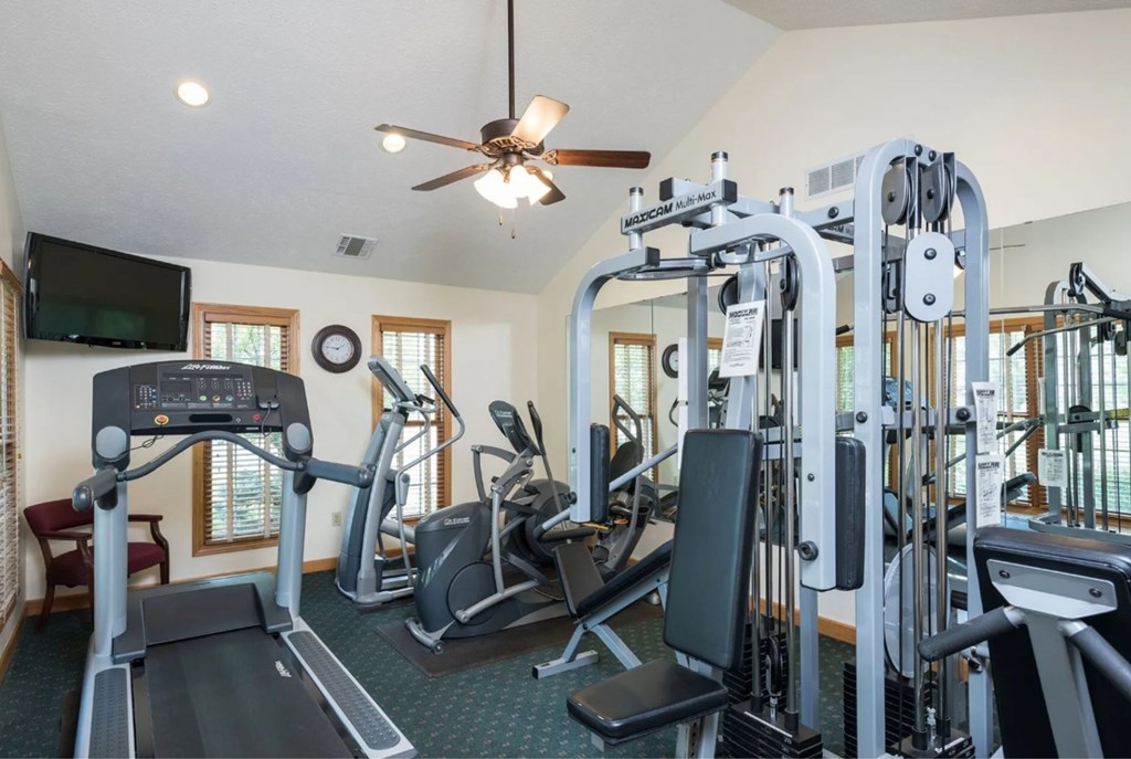 A spacious home gym with a variety of exercise equipment.