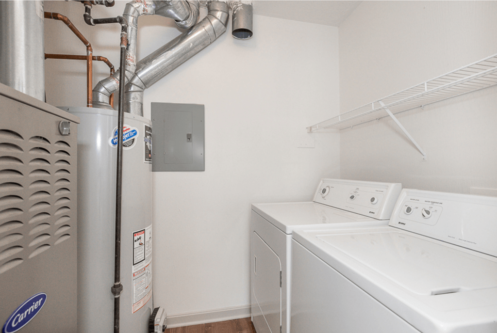 A small laundry room with a washer and dryer.