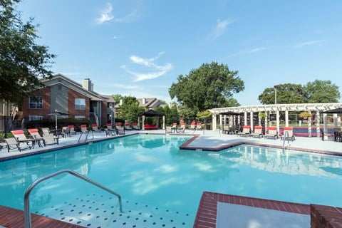 A large swimming pool with a metal ladder in the middle of it.