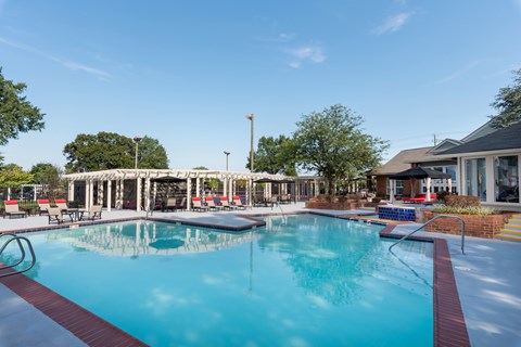 A large swimming pool with a red and white border.