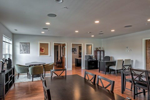 A modern dining room with a large table and chairs.