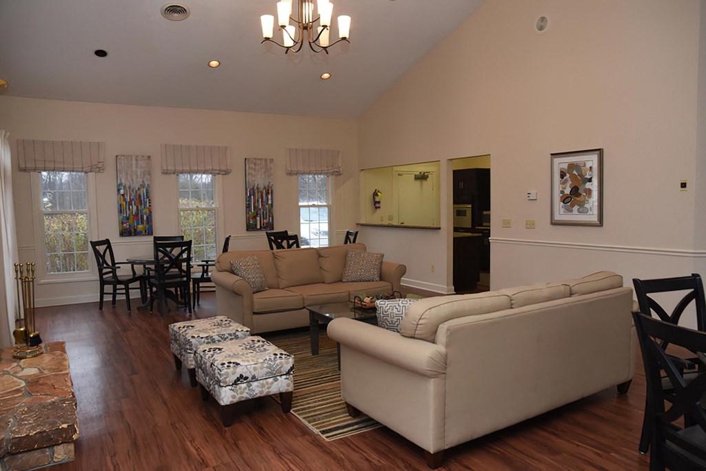 a living room and dining room with couches and a table