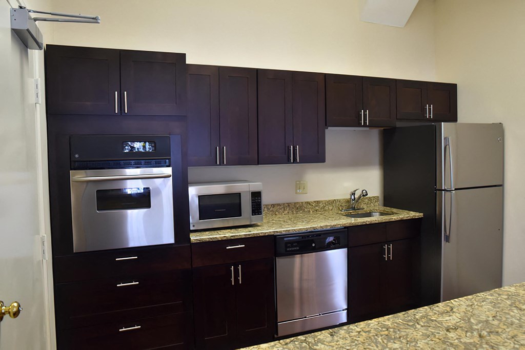 a kitchen with stainless steel appliances and granite counter tops