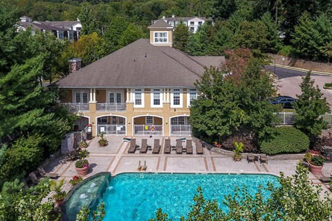arial view of a large mansion with a swimming pool