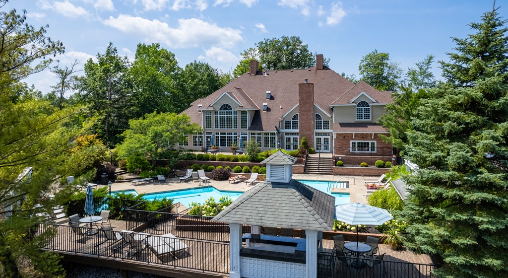 Exterior of back of clubhouse with outdoor pool