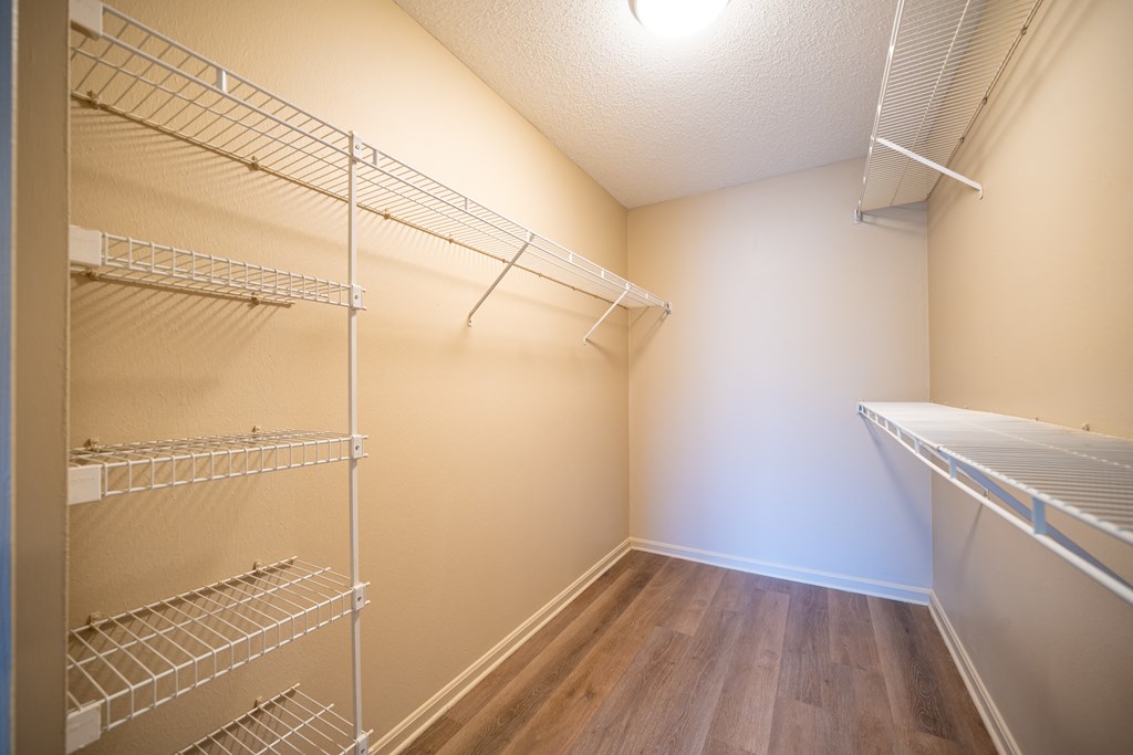 Walk in closet with shelving on the right and left