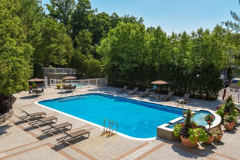 a large swimming pool with chairs around it