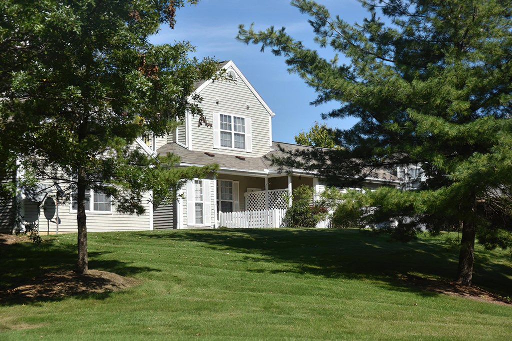 a large white house with trees in front of it