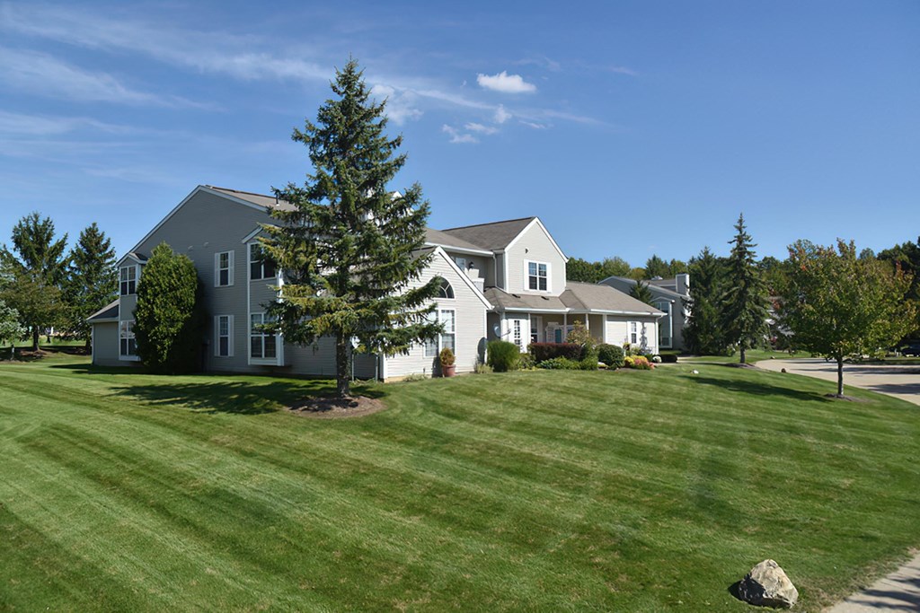 a large white house with a lawn in front of it