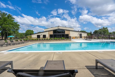 A pool with a building behind it.