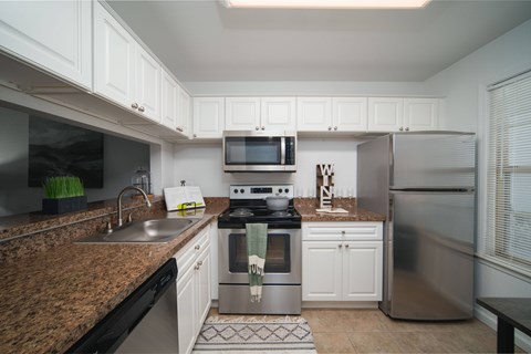 A kitchen with a stove top oven and a refrigerator.