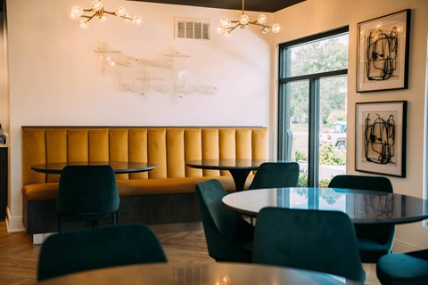 A dining room with a round table and chairs.