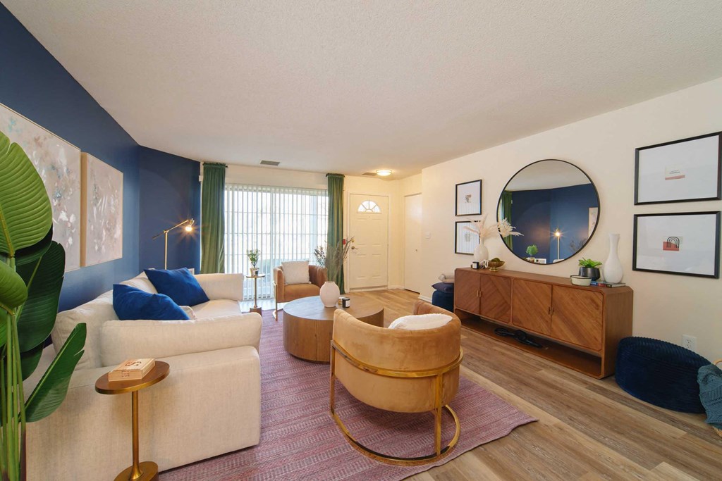 a living room with couches and chairs and a tv