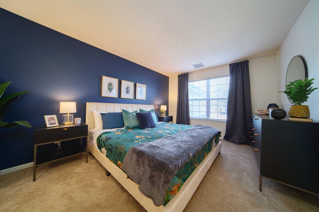 a bedroom with a bed and a window