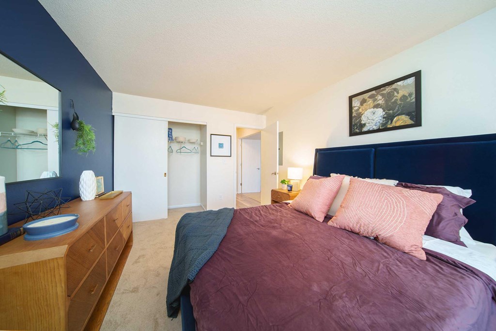 a bedroom with a bed and a dresser