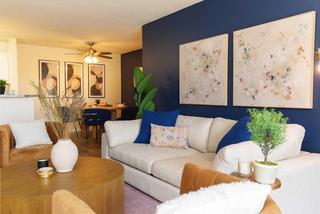 a living room with blue walls and a white couch