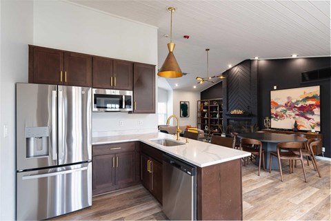 a kitchen with stainless steel appliances and a white counter top