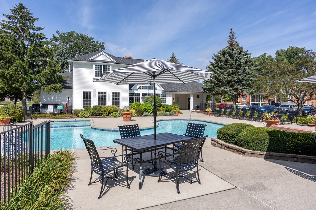 the preserve at ballantyne commons pool table and umbrella with apartment building in background