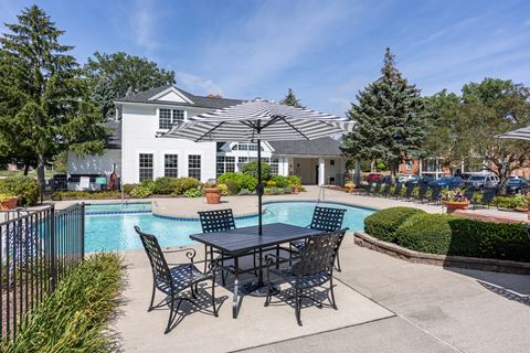 the preserve at ballantyne commons pool table and umbrella with apartment building in background