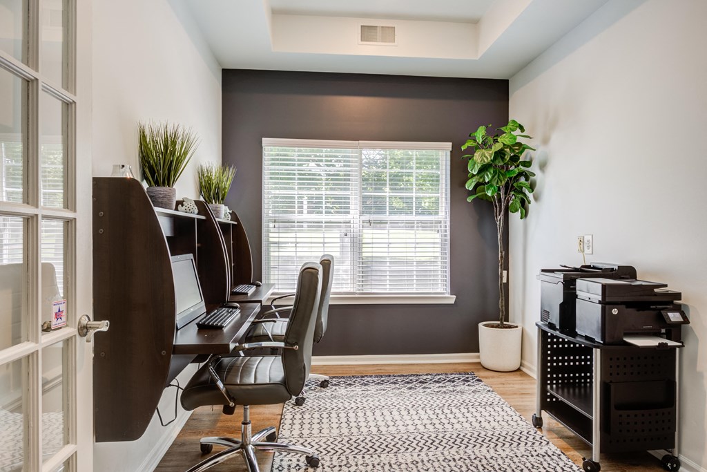 a home office with a desk and a window