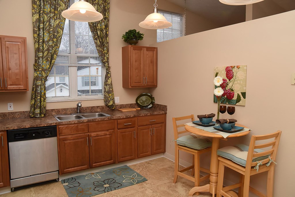 a kitchen with a table and chairs and a sink