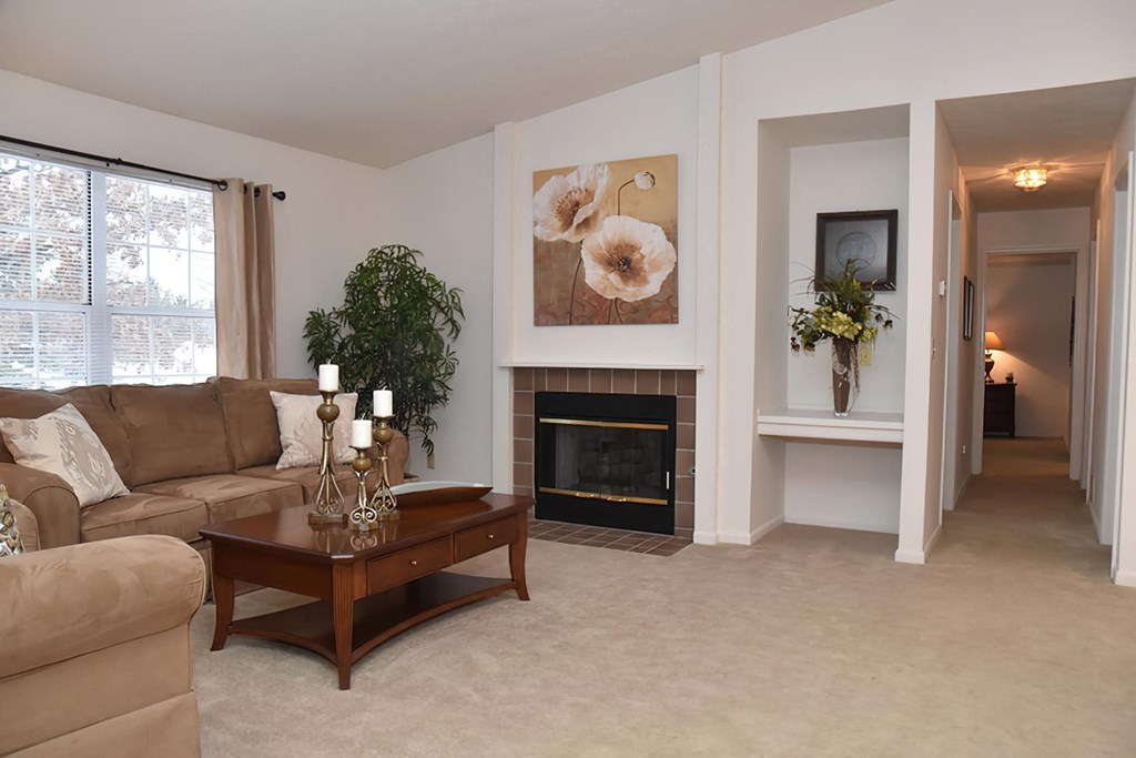 a living room with a couch and a fireplace