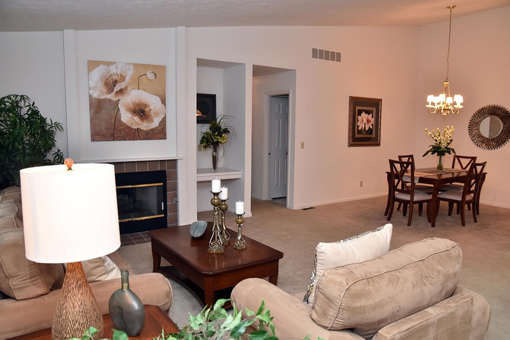 a living room with couches and a table and a fireplace