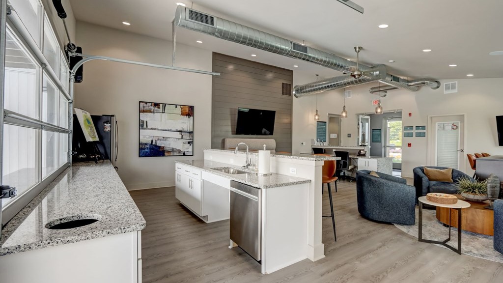 A modern kitchen with white appliances and a wooden floor.