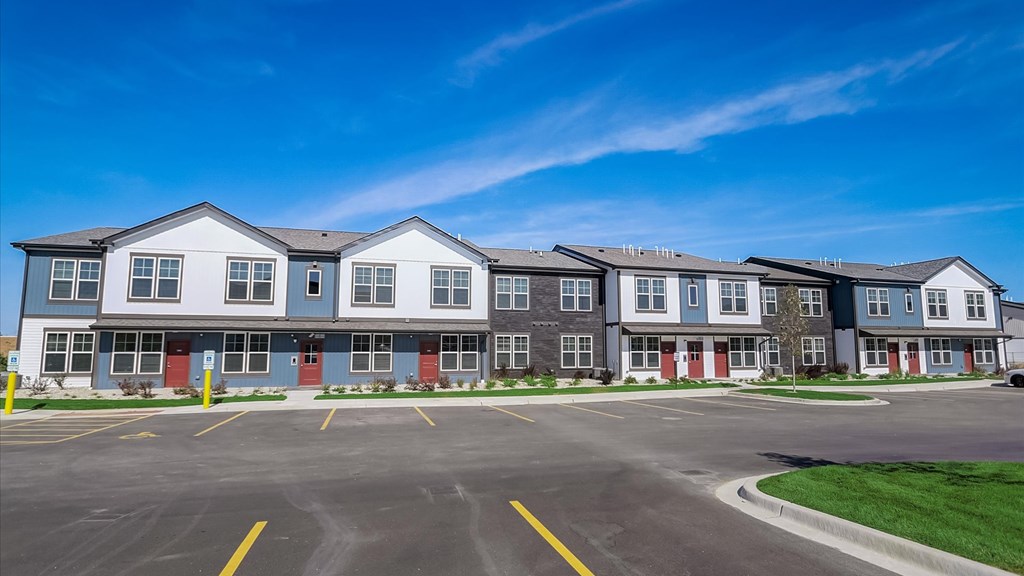 A large building with a parking lot in front of it.