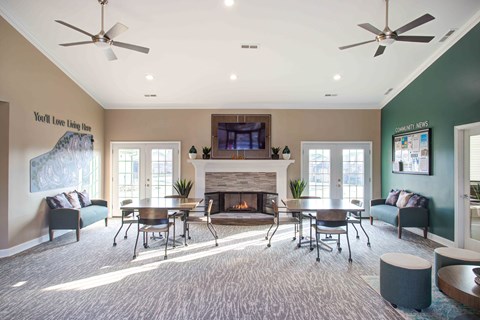 A living room with a fireplace and a tv on the wall.