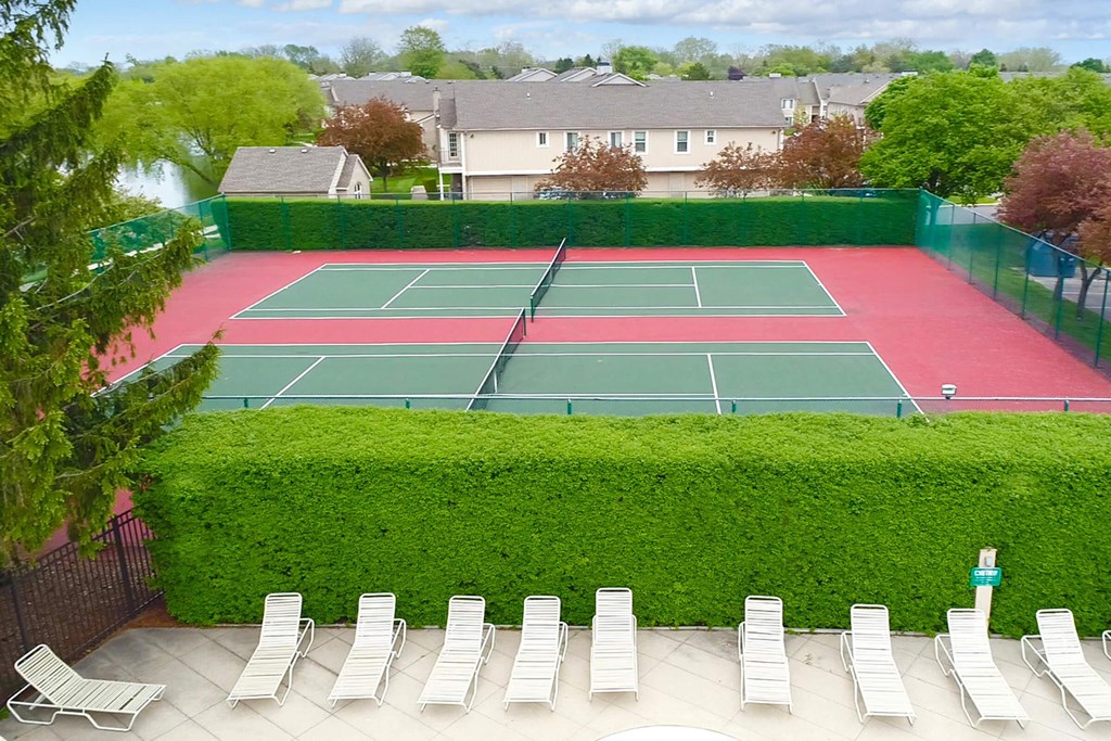 an aerial view of a tennis court and chairs on a patio